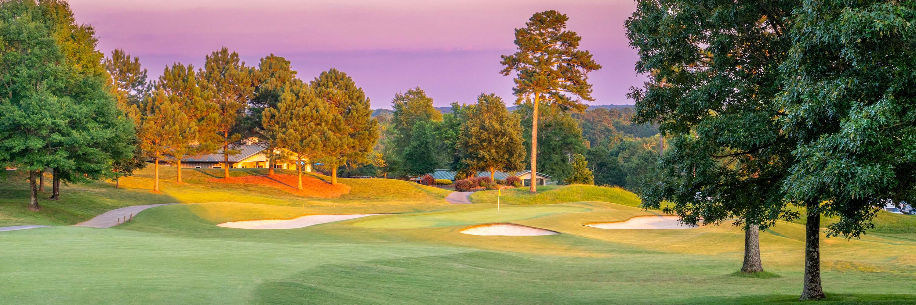 Chimneys Hole 18, lush grass and beautiful purple sunset